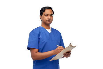 Image showing male doctor writing medical report on clipboard