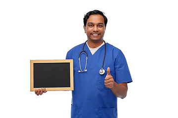 Image showing happy indian male doctor or nurse with chalkboard