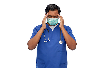 Image showing stressed indian doctor in mask having headache