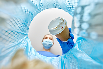 Image showing female doctor throwing coffee cup into trash can