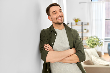 Image showing happy smiling man with crossed arms at home