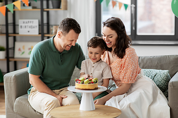 Image showing happy family with birthday cake at home