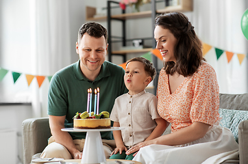 Image showing happy family with birthday cake at home