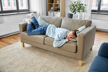 Image showing young man sleeping on sofa at home