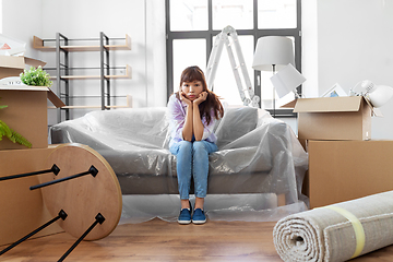 Image showing sad asian woman with stuff moving to new home