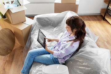 Image showing asian woman with tablet pc moving into new home