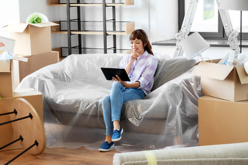 Image showing asian woman with tablet pc moving into new home