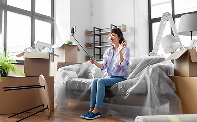 Image showing woman having video call and moving into new home