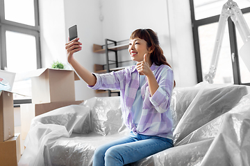 Image showing woman with phone having video call at new home