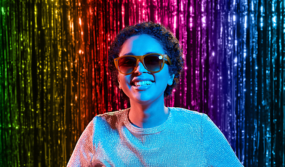 Image showing african woman in sunglasses over neon lights