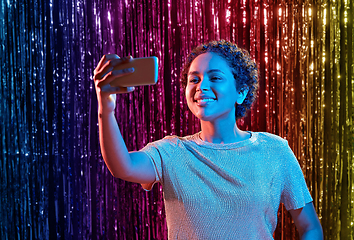 Image showing woman taking selfie with smartphone at party