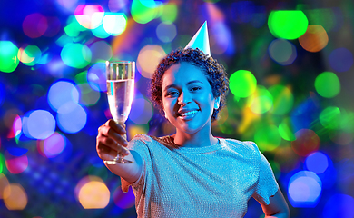 Image showing african woman in party cap with glass of champagne