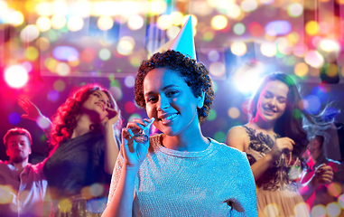 Image showing african woman with party blower at nightclub