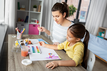 Image showing mother with little daughter drawing at home