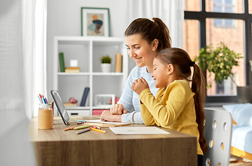 Image showing mother and daughter with tablet pc drawing at home