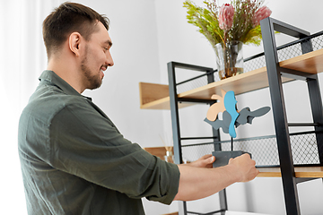 Image showing man decorating home with art in frame