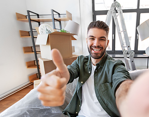 Image showing man having video call and moving into new home