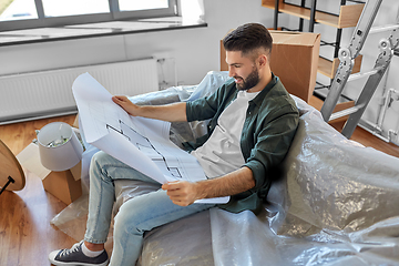 Image showing happy man with blueprint moving to new home