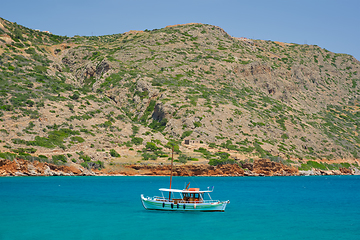 Image showing Greek traditional fishing boat in sea. Crete island, Greece