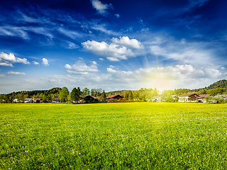 Image showing Countryside meadow field with sun and blue sky