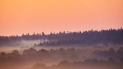 Image showing Misty morning of hilly area with ray of light.