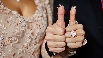 Image showing wedding rings on fingers painted with the bride and groom