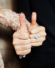 Image showing wedding rings on her fingers painted with the bride and groom