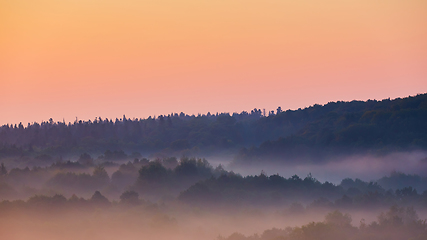 Image showing Misty morning of hilly area with ray of light.