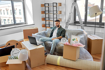 Image showing man with laptop computer and moving into new home