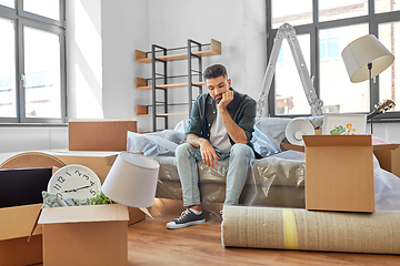 Image showing sad man with boxes moving to new home