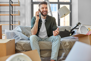 Image showing happy man calling on smartphone moving to new home