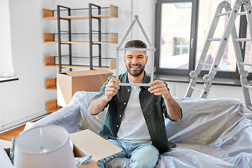 Image showing happy man with boxes moving to new home