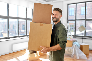 Image showing happy man with boxes moving to new home