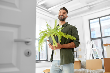 Image showing happy man with fern flower and moving to new home