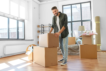 Image showing happy man with boxes moving to new home