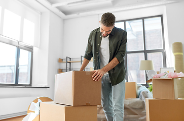 Image showing happy man with boxes moving to new home