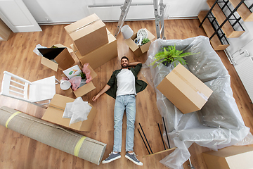 Image showing happy man with boxes moving to new home