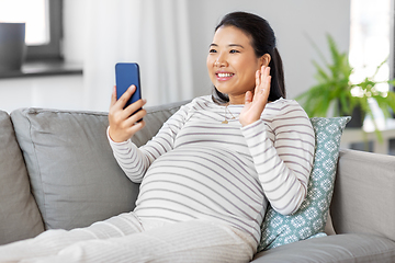 Image showing happy pregnant woman having video call on phone