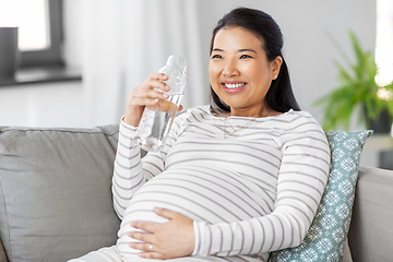 Image showing pregnant woman with water in glass bottle at home