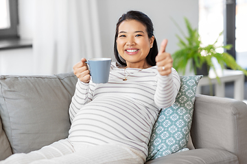 Image showing happy pregnant woman drinking tea at home