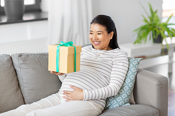 Image showing happy pregnant woman with gift box at home