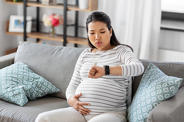 Image showing pregnant woman having labor contractions at home