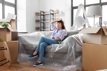 Image showing tired asian woman with stuff moving to new home