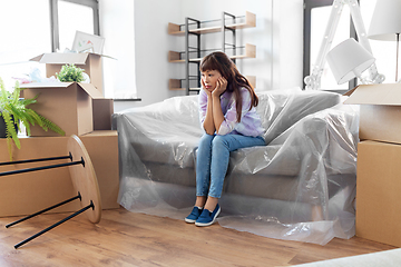 Image showing sad asian woman with stuff moving to new home
