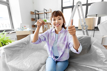 Image showing asian woman with keys taking at new home