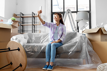 Image showing woman with phone having video call at new home