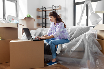 Image showing woman with laptop moving into new home