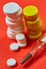 Image showing Mercury thermometer and medical pills on background