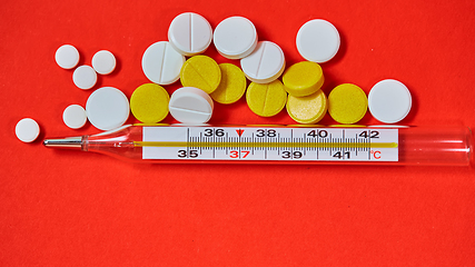 Image showing Mercury thermometer and medical pills on background