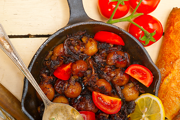 Image showing Baby cuttle fish roasted on iron skillet